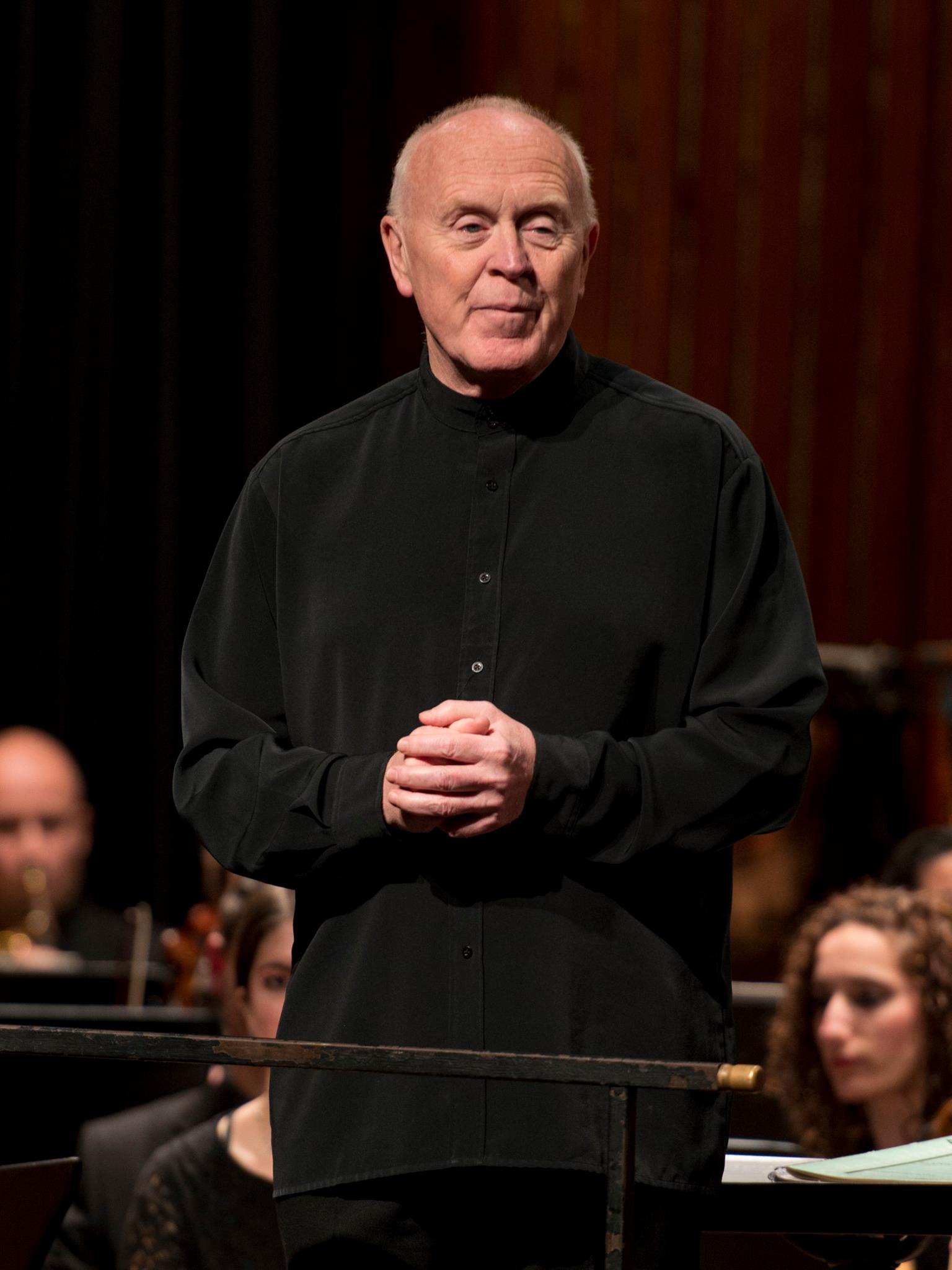 Peter Stark on stage with an orchestra